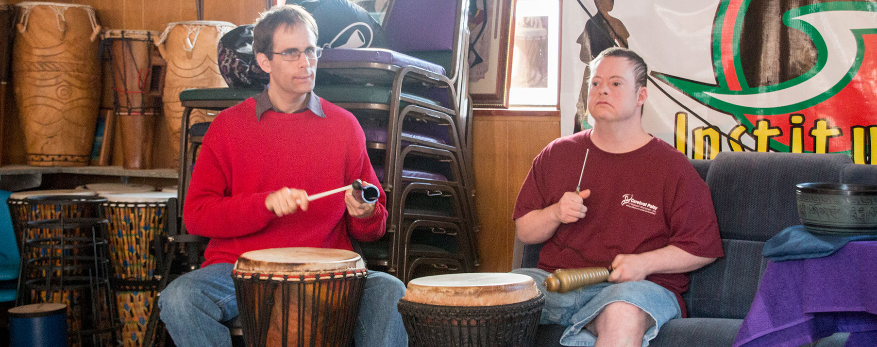 Two covey clients playing the drums.