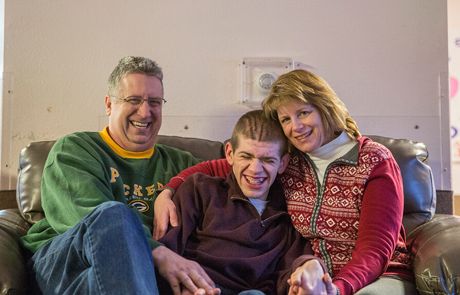 Two parents with their autistic son.