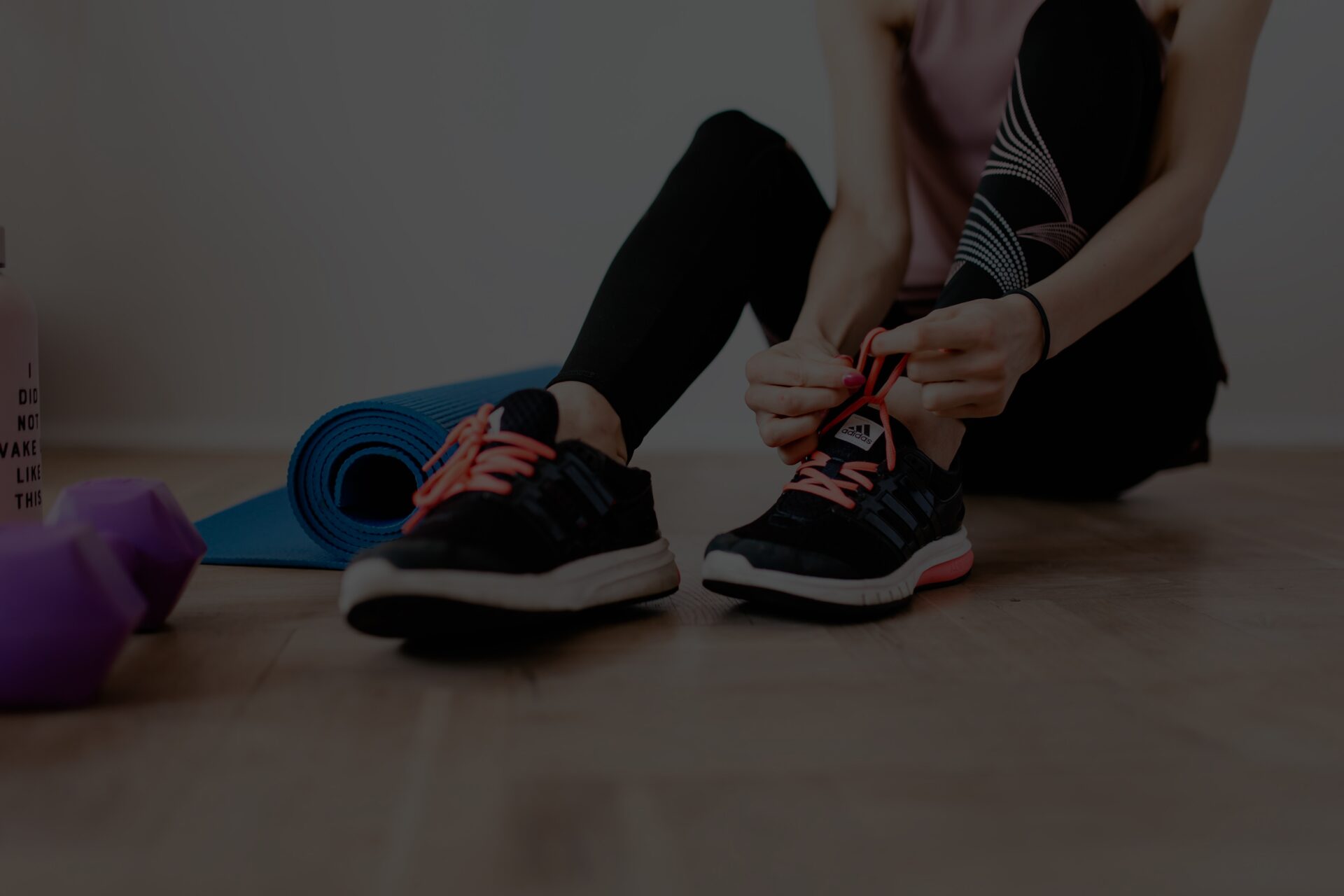 A girl tying her shoes.