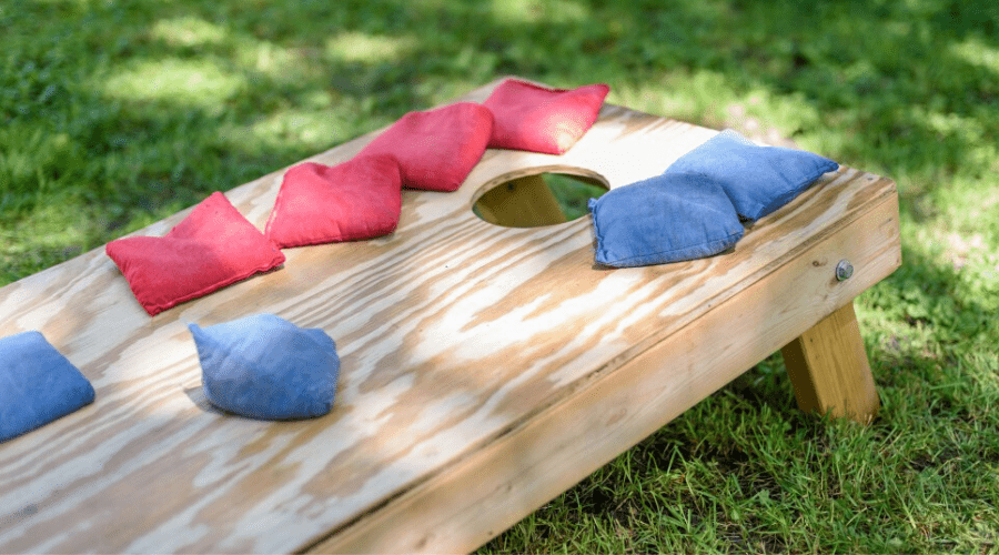 The board in cornhole with bags on top of it.