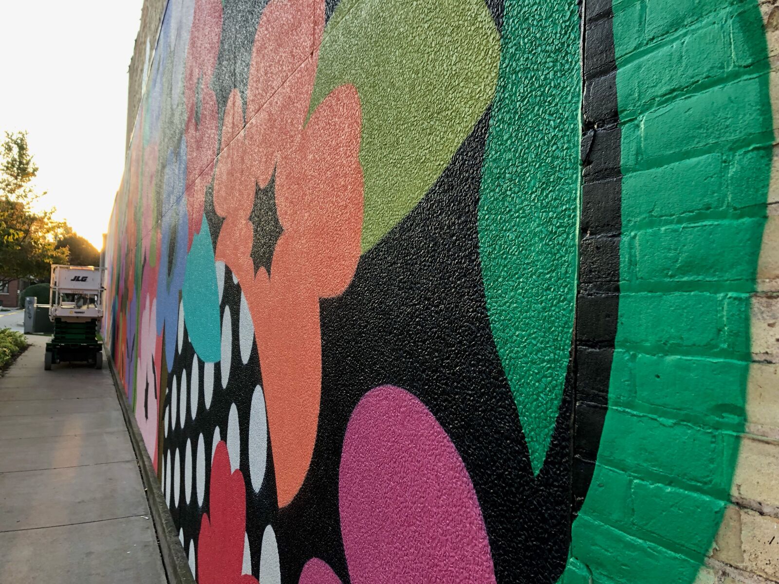 A brick wall with a mural painted on it.